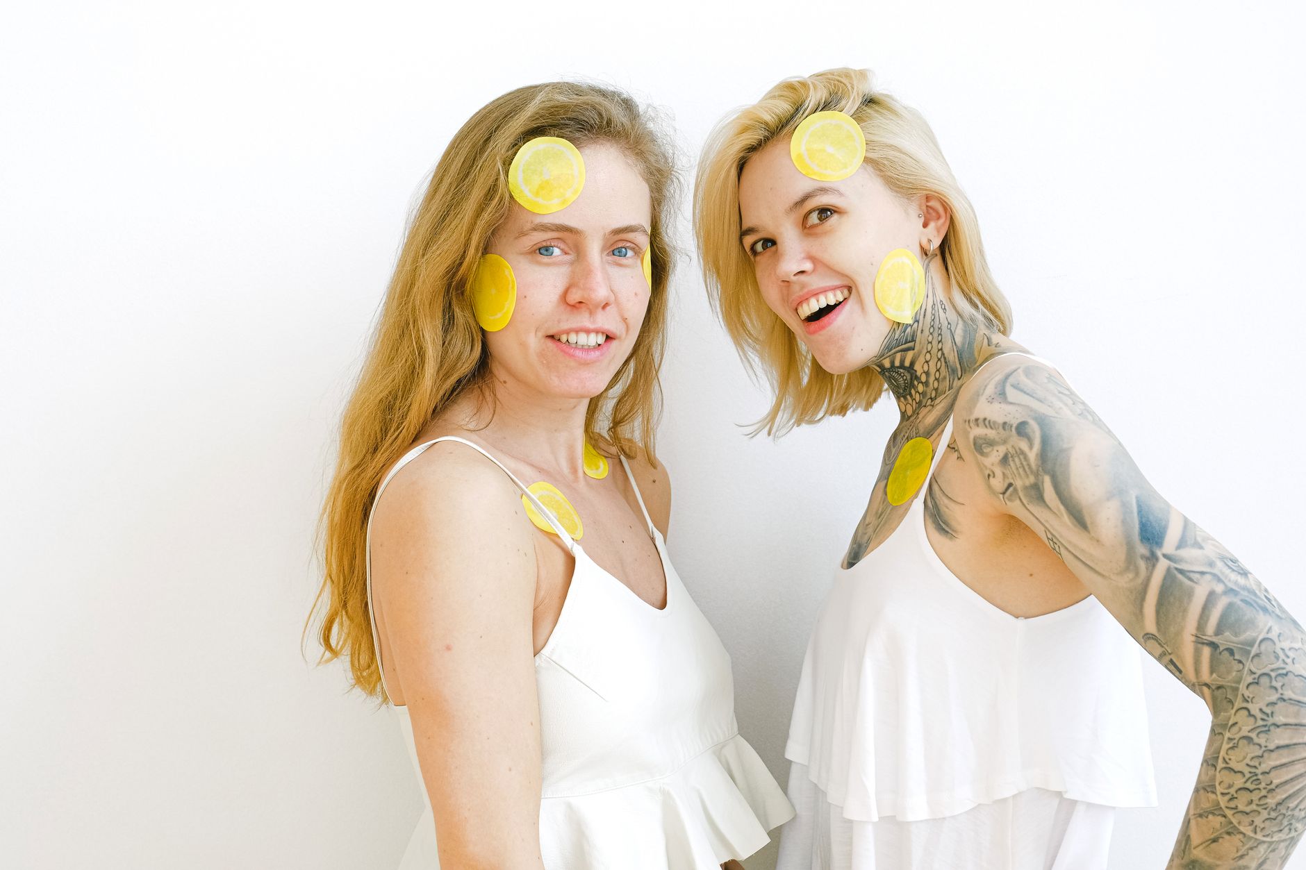 Fresh lemons arranged on white plate with yellow background representing citrus freshness and vitality